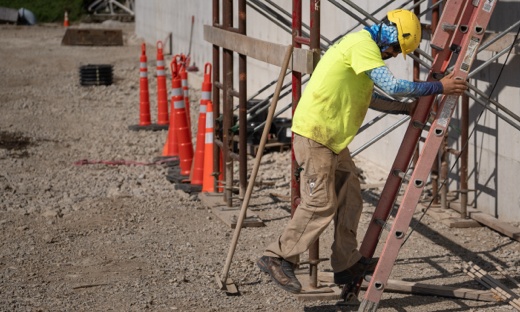 Construction Worker Stepping Down from Ladder